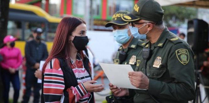 Policía de Bogotá dialoga con una mujer subana, en las calles de la localidad
